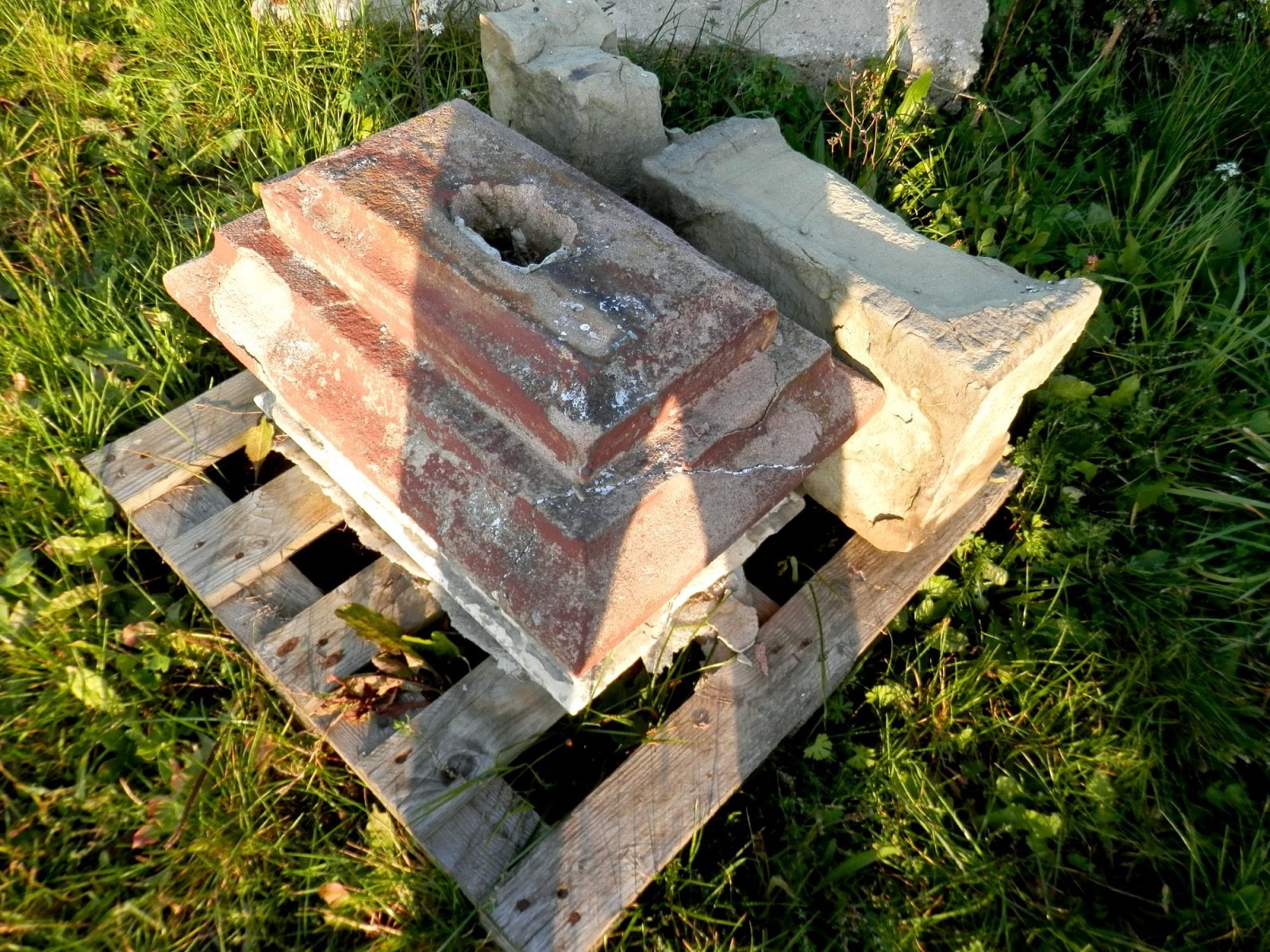 Zbytky kamenného kříže určené k opravě