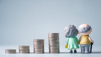 Postavičky seniorů a mincí znázorňující spoření na stáří.