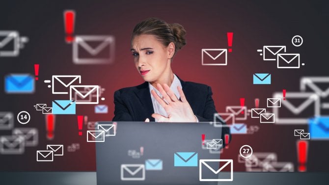 Podnikatelka v kostýmku sedí na pracovišti, dívá se na obrazovku notebooku a rukou ukazuje gesto „stop“, což symbolizuje koncept zastavení nevyžádaných e-mailů. Koncept nejistoty osobních údajů.