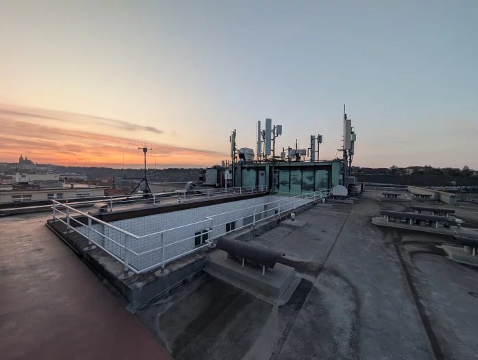 Palác Merkur na ulici Revoluční je jednou z důležitých lokalit pro šíření mobilního signálu po Praze. Vysílače zde mají všichni tři operátoři, každý používá své technologie a dodavatele. V galerii lze vidět hlavně sajtu T-Mobilu. Ten z Merkuru svítí na centrum města a dokáže částečně cílit i přes řeku na Letnou. Používá frekvence 700, 800, 1800 a 2100 MHz a nově také 3,5 GHz. Rozvaděč má aktivní klimatizaci, protože je umístěn na střeše a v létě dostávat zabrat od sluníčka. Možné přehřívání lze detekovat automaticky na dálku.