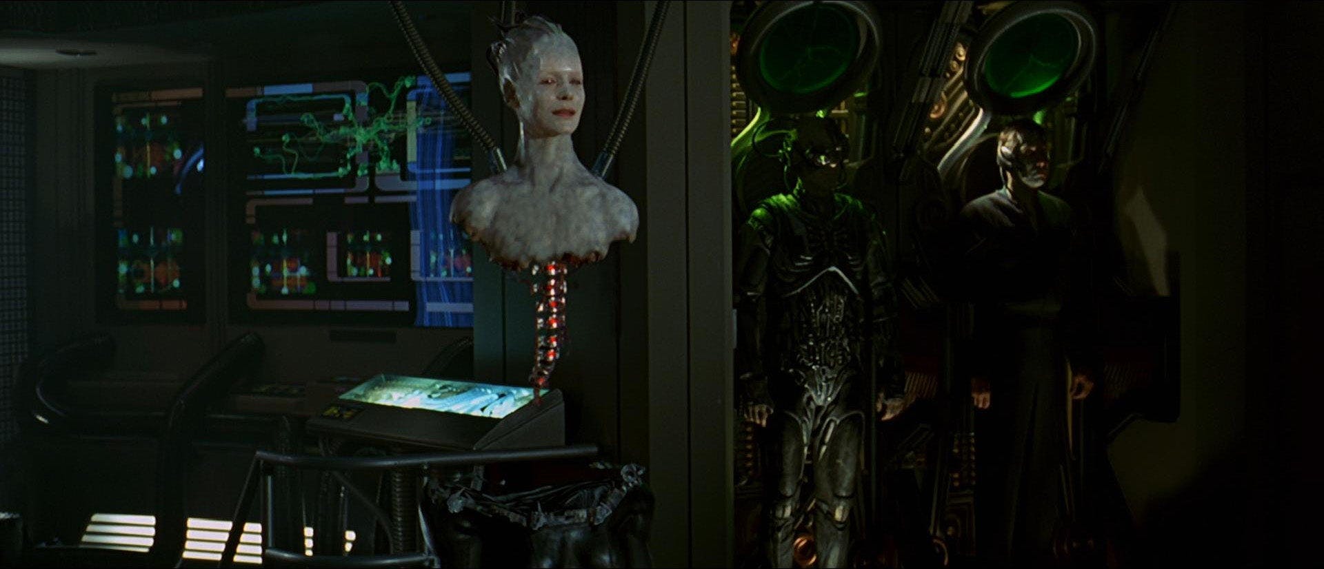 Borgská královna s technologickou páteří a Borgem v pozadí ve filmu Star Trek: První kontakt