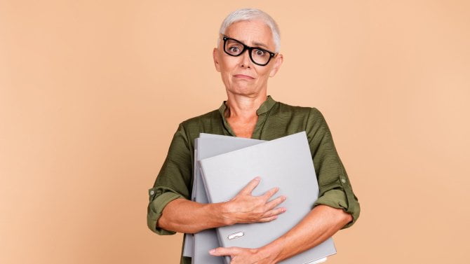 Hezká seniorka drží dokumenty