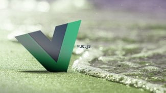 Logo projektu Vue.js zapíchnuté na pláži